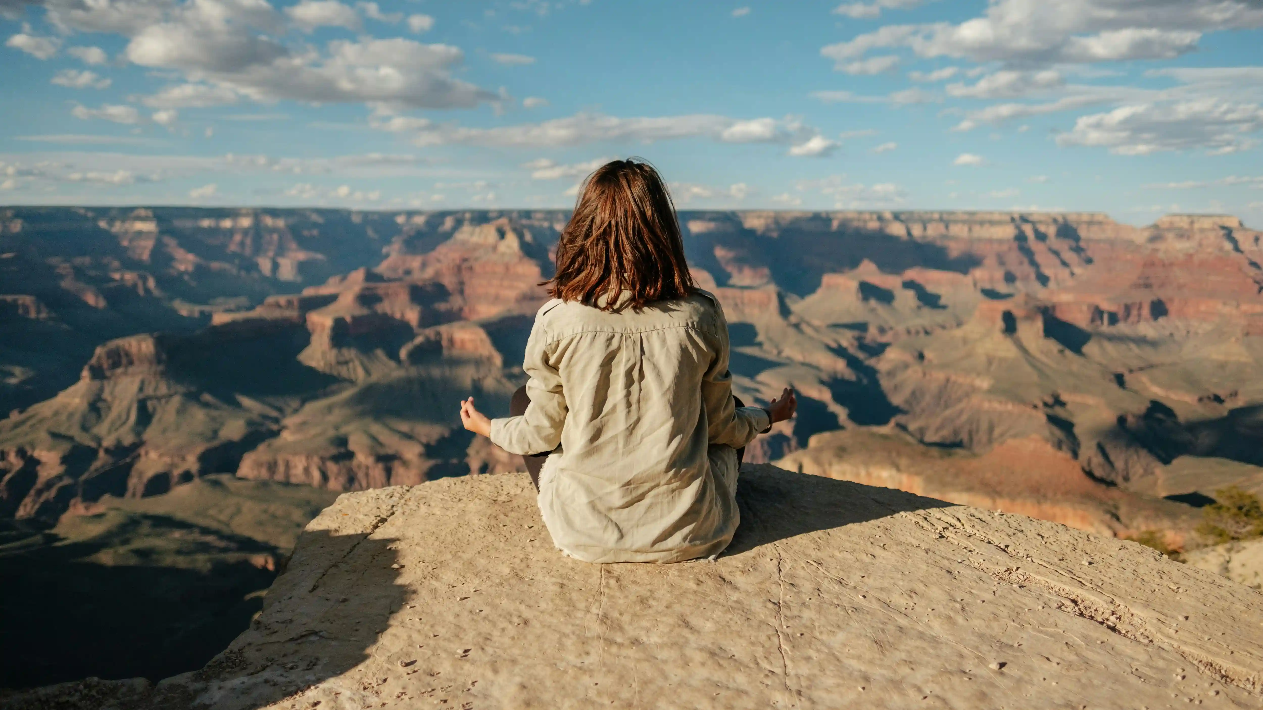 A serene person sitting in a comfortable meditation pose, embodying inner peace